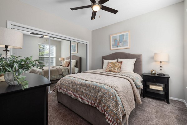 Cozy bedroom with modern furnishings at Cary Greens at Preston Apartments