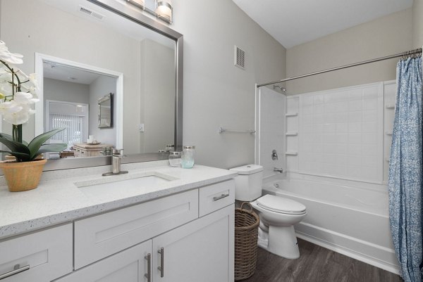 Modern bathroom with sleek fixtures at Cary Greens at Preston Apartments, offering luxury living spaces