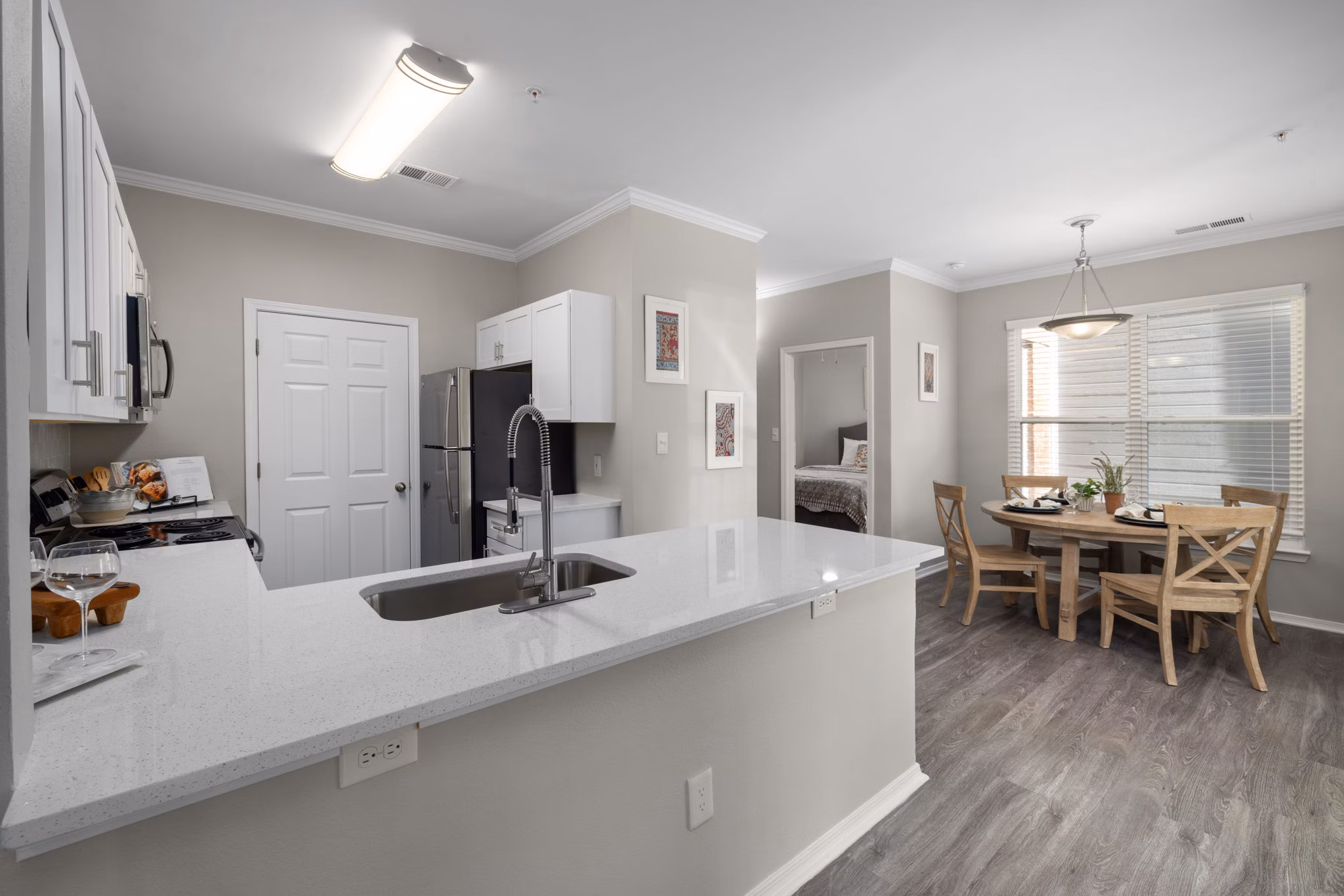 Modern kitchen with stainless steel appliances at Cary Greens at Preston Apartments
