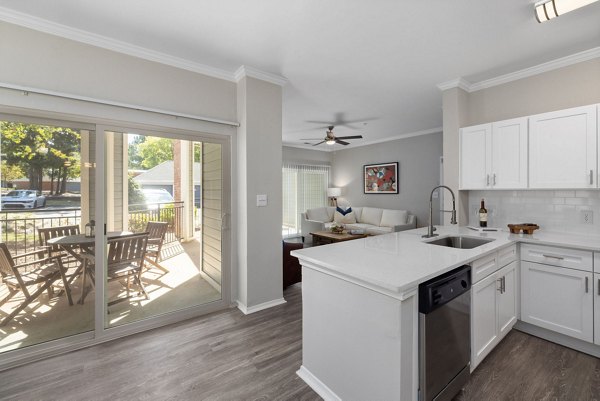 Sleek modern kitchen with stainless steel appliances at Cary Greens at Preston luxury apartments