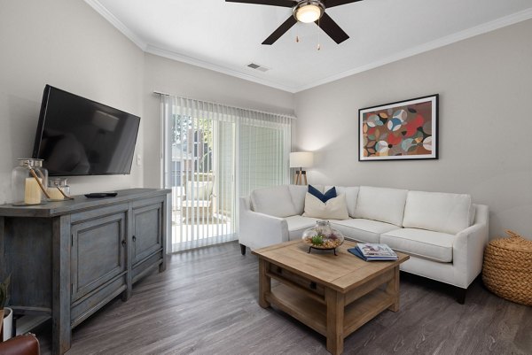 Spacious living room with modern design and elegant furnishings at Cary Greens at Preston Apartments