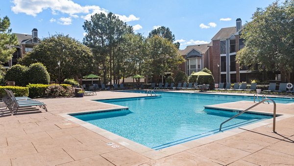 Modern pool area featuring lounge chairs at Cary Greens at Preston Apartments, a Greystar luxury community in Cary