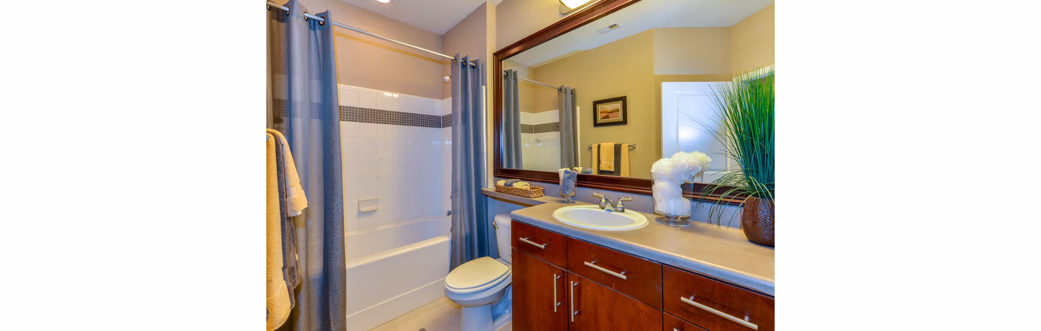 Bathroom with modern fixtures and granite countertops at Avana City North Apartments