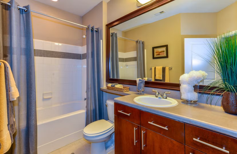 Bathroom with modern fixtures and granite countertops at Avana City North Apartments