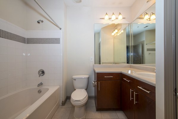 Modern bathroom featuring sleek fixtures and marble countertops at Avana City North Apartments