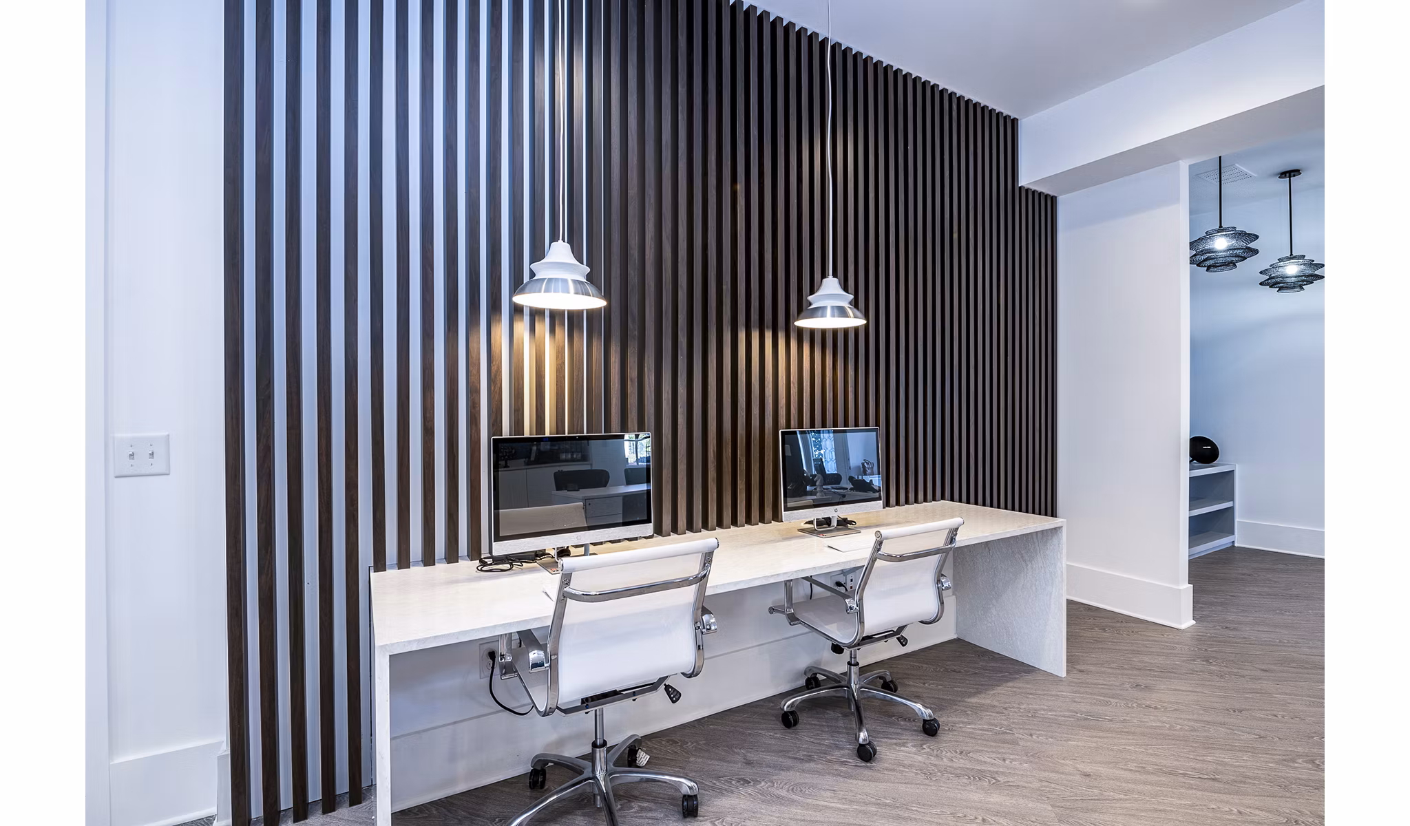 Modern business center at Avana City North Apartments with sleek workstations and collaborative spaces, ideal for remote work in a luxury setting
