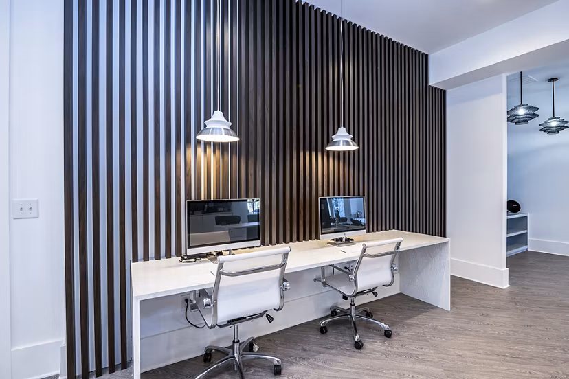 Modern business center at Avana City North Apartments with sleek workstations and collaborative spaces, ideal for remote work in a luxury setting