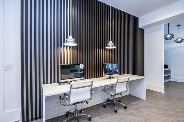 Modern business center at Avana City North Apartments with sleek workstations and collaborative spaces, ideal for remote work in a luxury setting