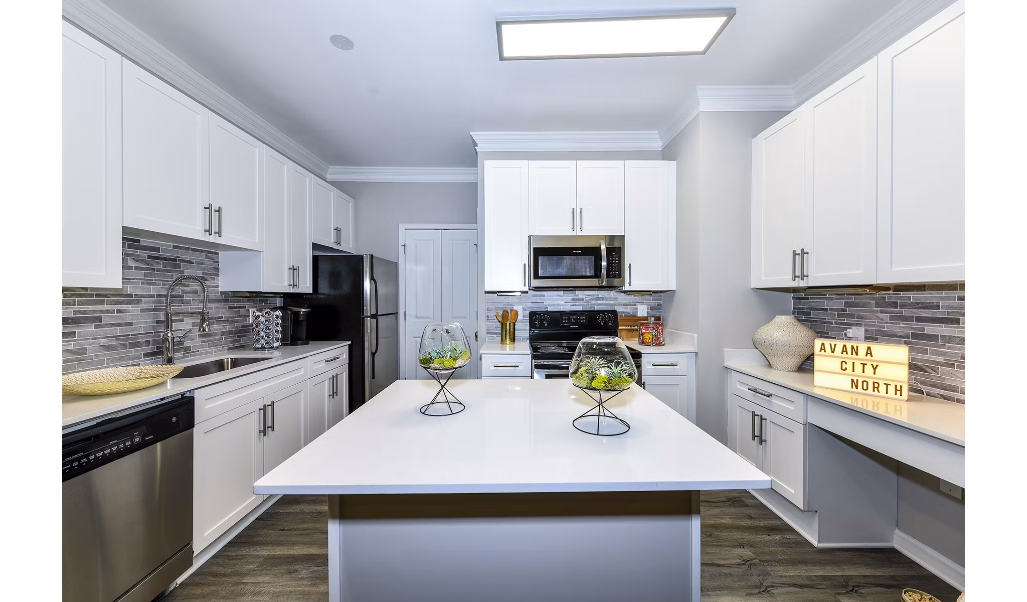 Modern kitchen with stainless steel appliances at Avana City North Apartments, ideal for culinary enthusiasts