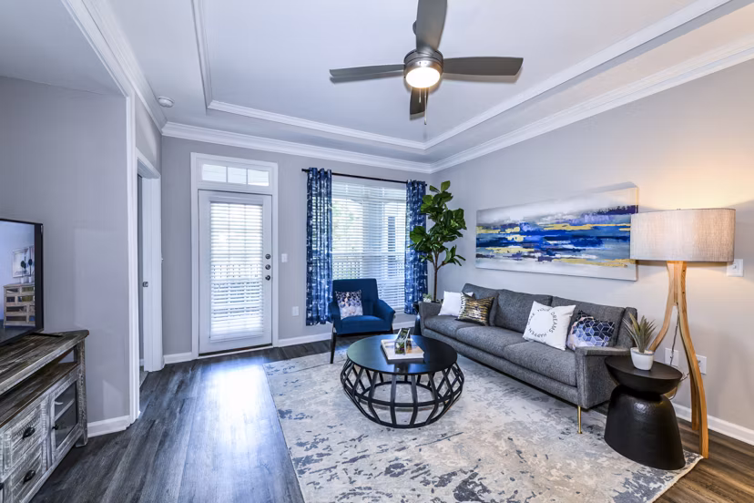 Spacious living room with contemporary furniture in Avana City North Apartments