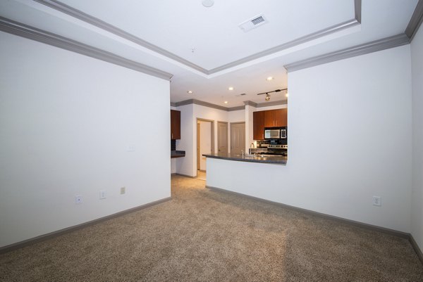 Spacious living room with modern decor at Avana City North Apartments