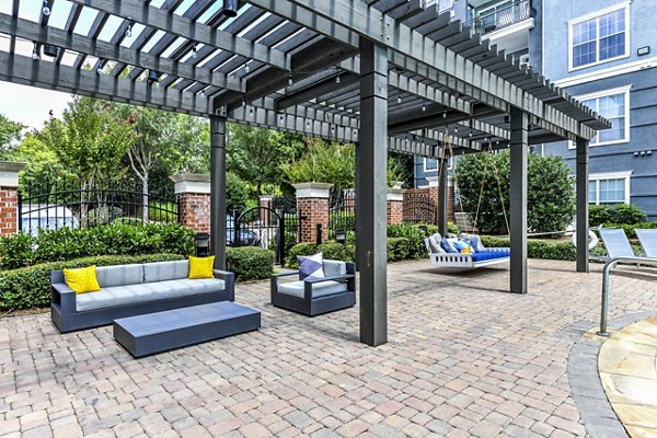 Poolside relaxation area with stylish patio furniture at Avana City North Apartments