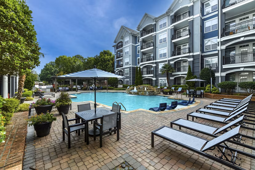 Outdoor pool with lounge chairs at Avana City North Apartments for leisure and relaxation