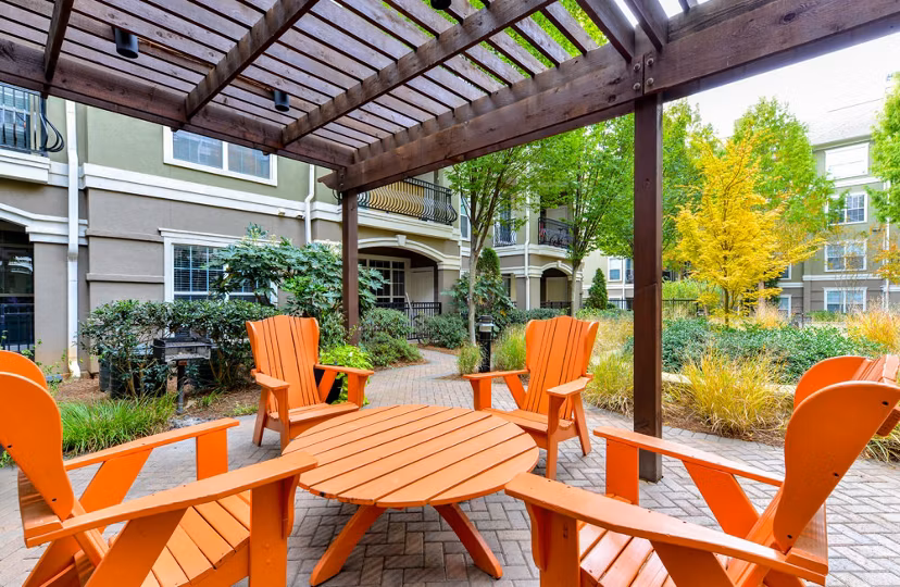 Chic patio area with cozy seating at Avana City North Apartments, perfect for outdoor relaxation and social gatherings