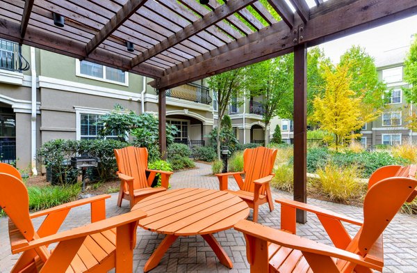 Chic patio area with cozy seating at Avana City North Apartments, perfect for outdoor relaxation and social gatherings