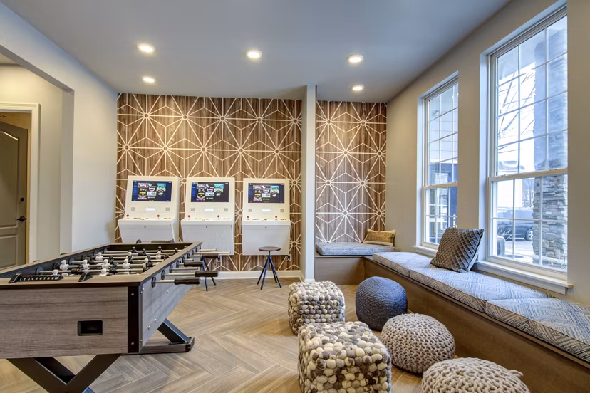 Game room with pool table and lounge seating at The Grand Reserve Apartments featuring luxury amenities for relaxation and entertainment