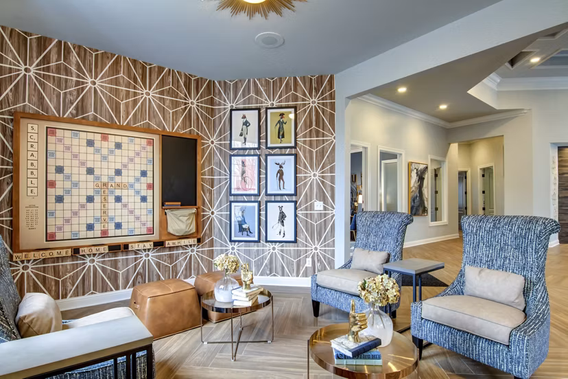 Game room with pool table and lounge seating at The Grand Reserve Apartments