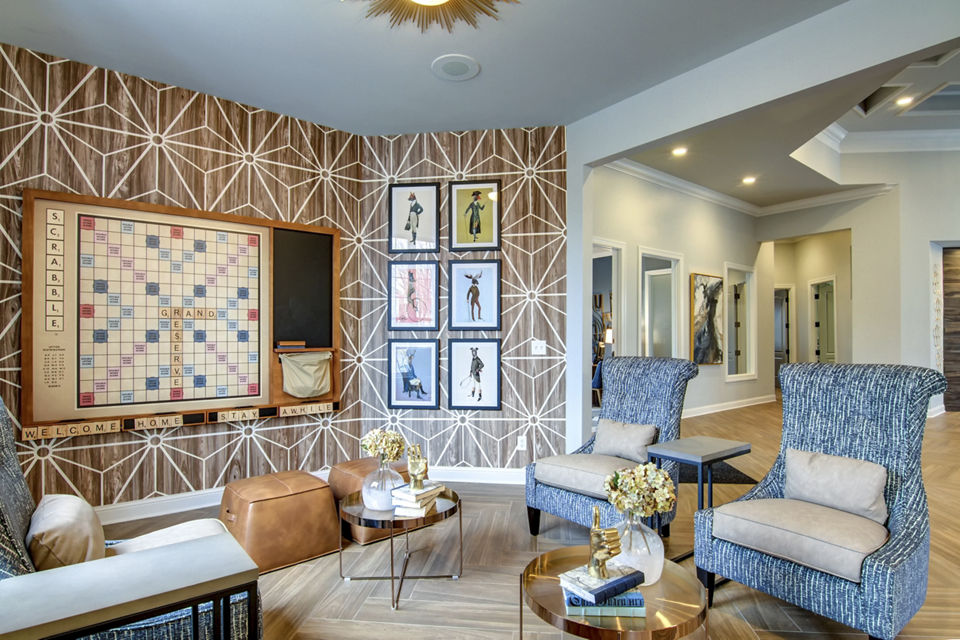 Game room with pool table and lounge seating at The Grand Reserve Apartments