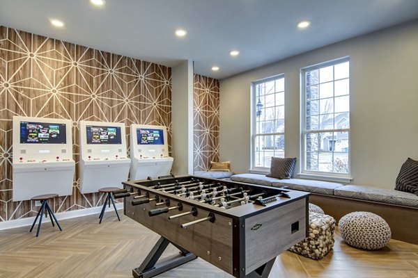 Game room with billiards table and lounge seating at The Grand Reserve Apartments