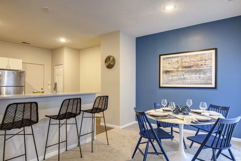 Spacious dining room with modern furnishings at The Grand Reserve Apartments