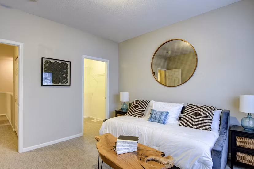 Modern living room with elegant decor and plush seating in The Grand Reserve Apartments