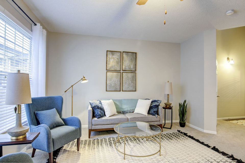 Living room featuring elegant decor and plush seating at The Grand Reserve Apartments