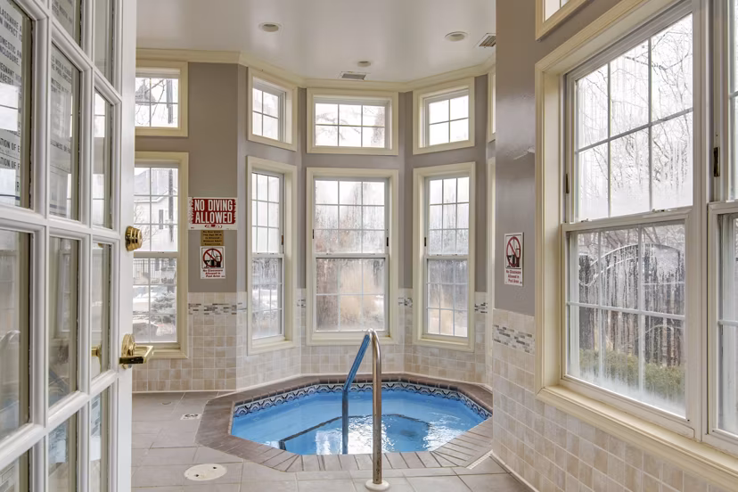 Relaxing hot tub at The Grand Reserve Apartments in a lush garden setting