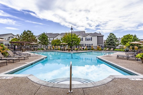 Luxurious outdoor pool area at The Grand Reserve Apartments featuring modern lounge seating