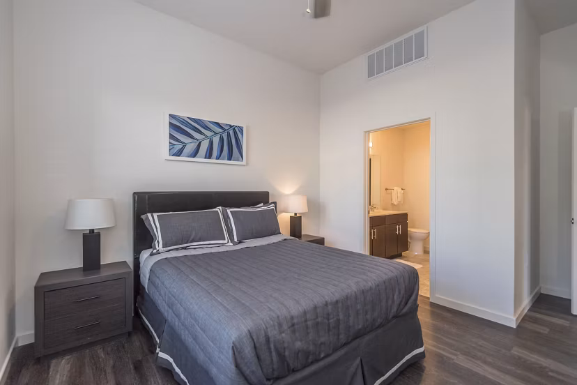 Bedroom featuring modern decor and natural light at Sunnen Station Apartments