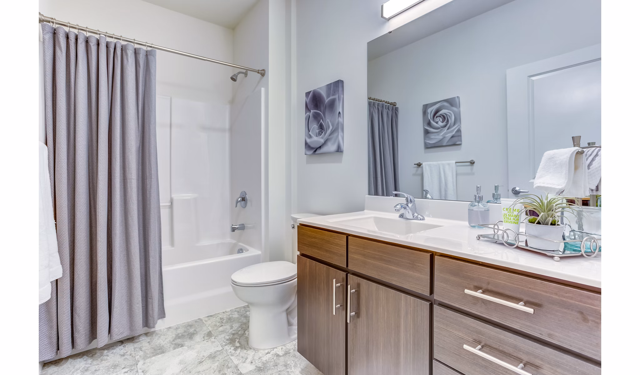 Modern bathroom featuring sleek fixtures and ample lighting in Sunnen Station Apartments