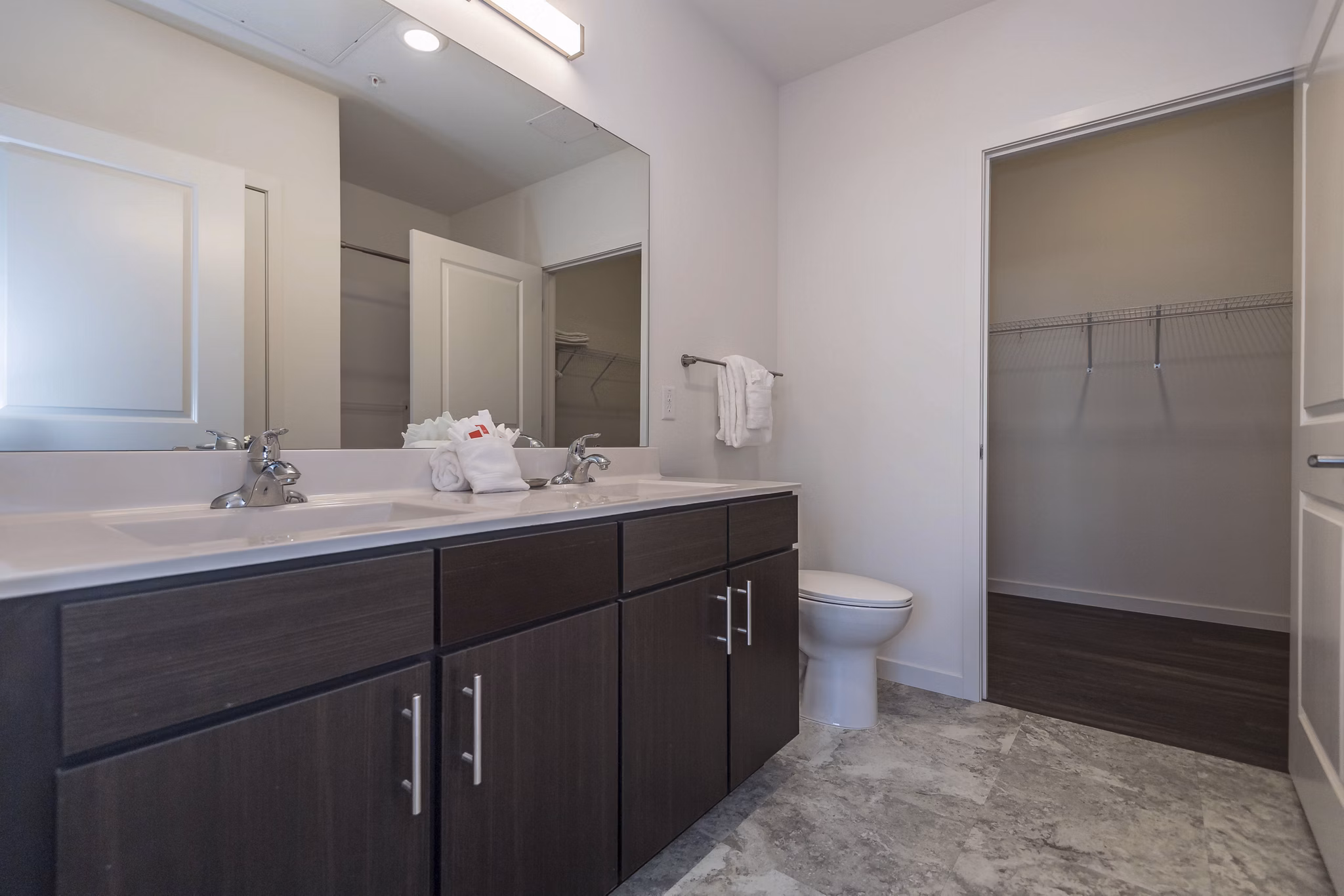 Modern bathroom with sleek fixtures at Sunnen Station Apartments, featuring luxury tile flooring and spacious vanity