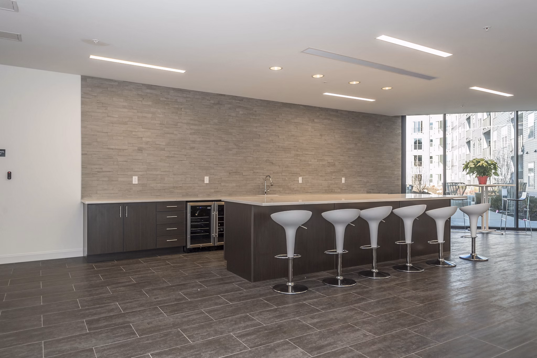 Modern clubhouse with cozy seating and large screen TV at Sunnen Station Apartments, a vibrant community offering luxury amenities