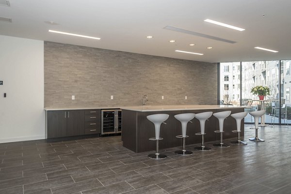 Modern clubhouse with cozy seating and large screen TV at Sunnen Station Apartments, a vibrant community offering luxury amenities
