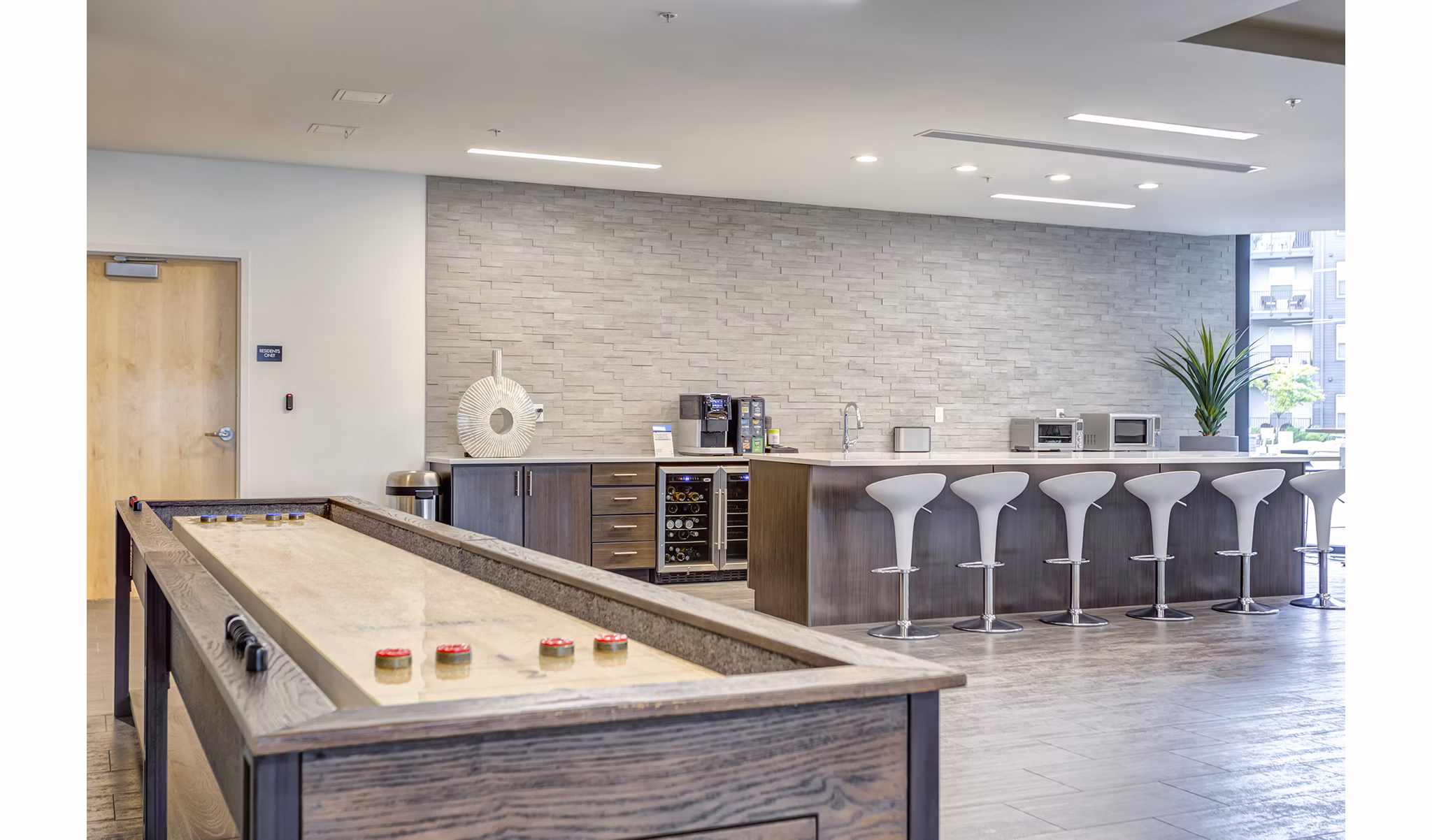 Modern clubhouse with lounge seating and pool table at Sunnen Station Apartments, offering luxury living and community events