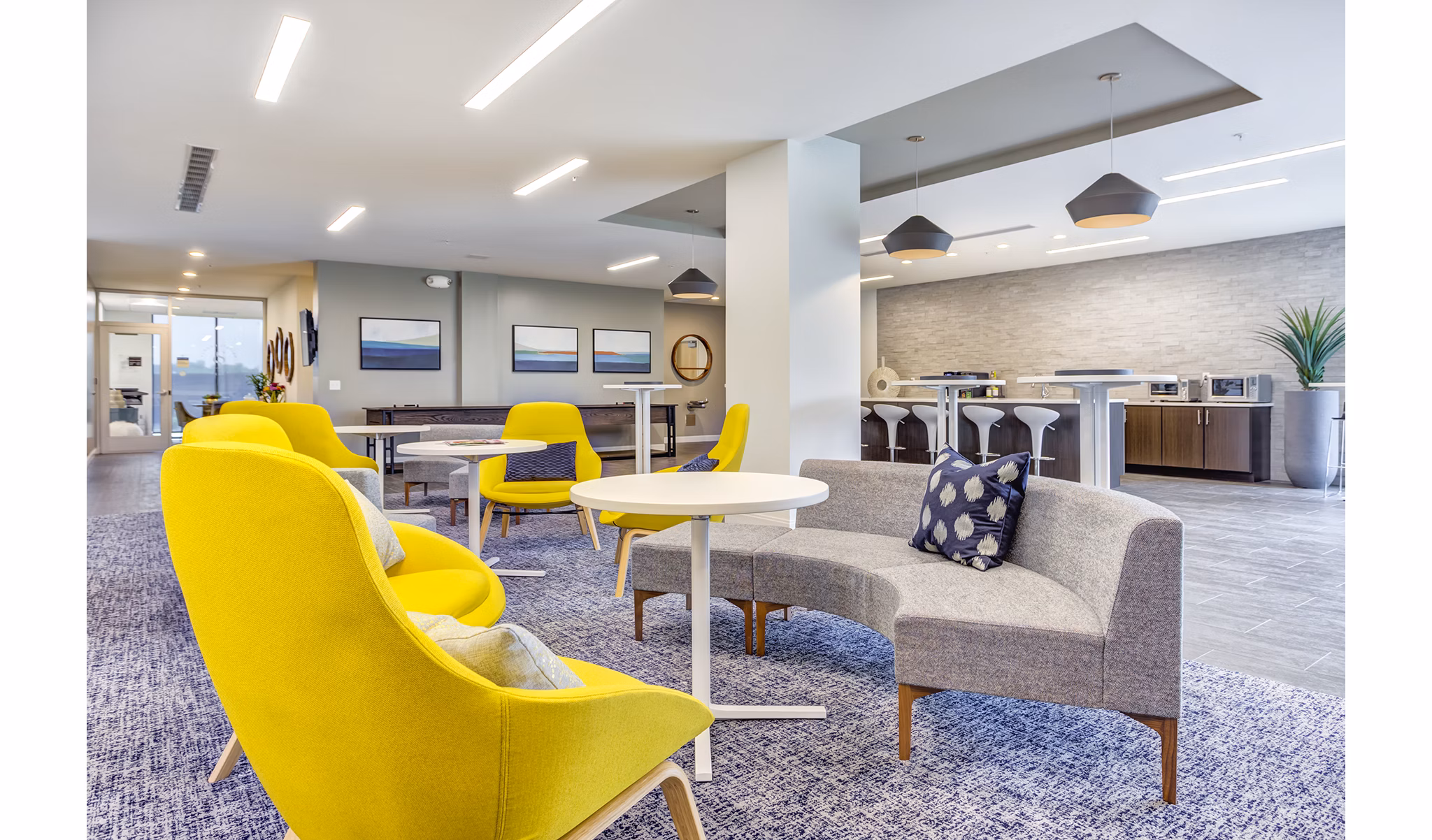 Clubhouse featuring modern design and seating areas at Sunnen Station Apartments