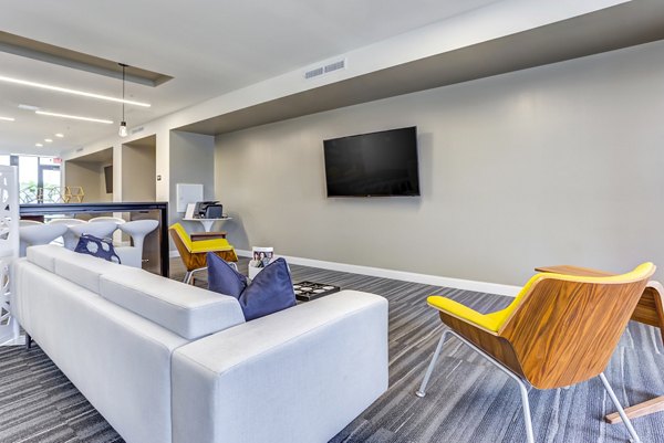 Modern clubhouse with comfortable seating and entertainment options at Sunnen Station Apartments