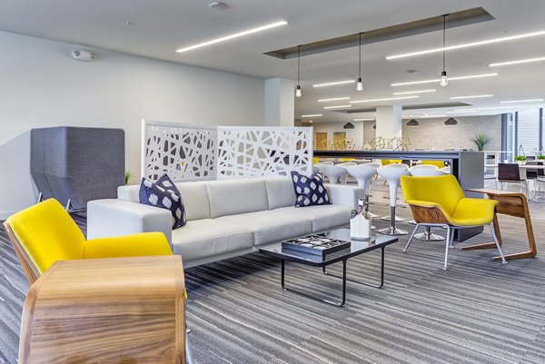 Elegant clubhouse with modern decor at Sunnen Station Apartments, ideal for social gatherings and events in a vibrant community setting