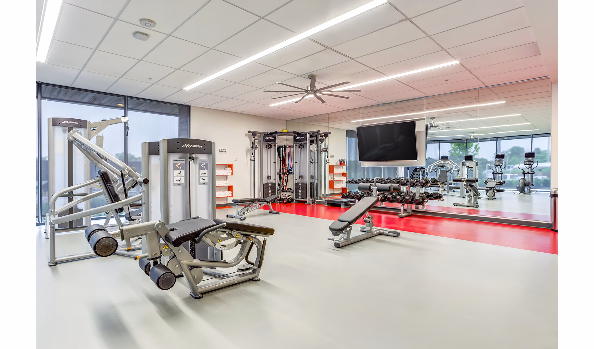 State-of-the-art fitness center at Sunnen Station Apartments with modern equipment and spacious workout area