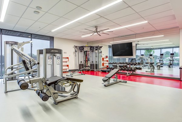 State-of-the-art fitness center at Sunnen Station Apartments with modern equipment and spacious workout area