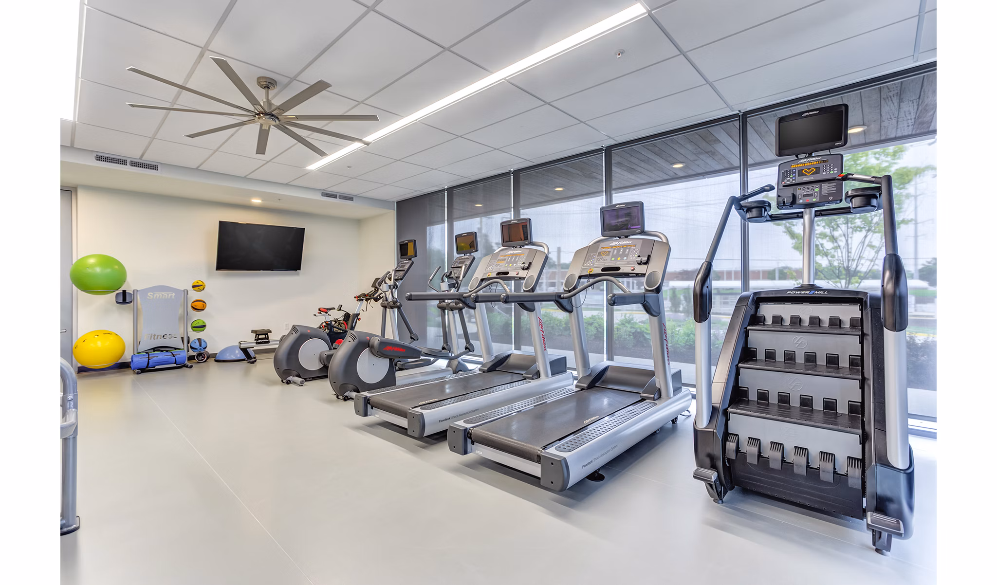 Spacious fitness center with state-of-the-art equipment at Sunnen Station Apartments, perfect for active lifestyles and wellness enthusiasts