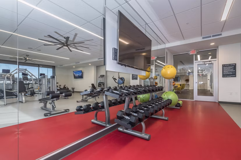 Modern fitness center with state-of-the-art equipment at Sunnen Station Apartments