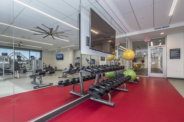 Modern fitness center with state-of-the-art equipment at Sunnen Station Apartments