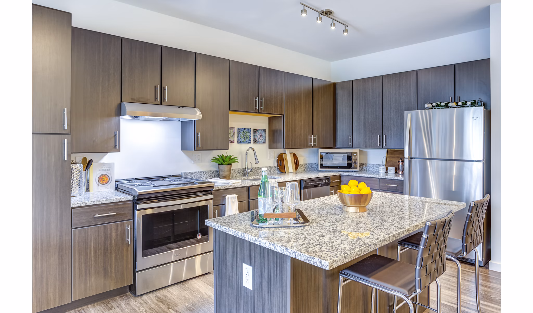 Modern kitchen featuring stainless steel appliances at Sunnen Station Apartments