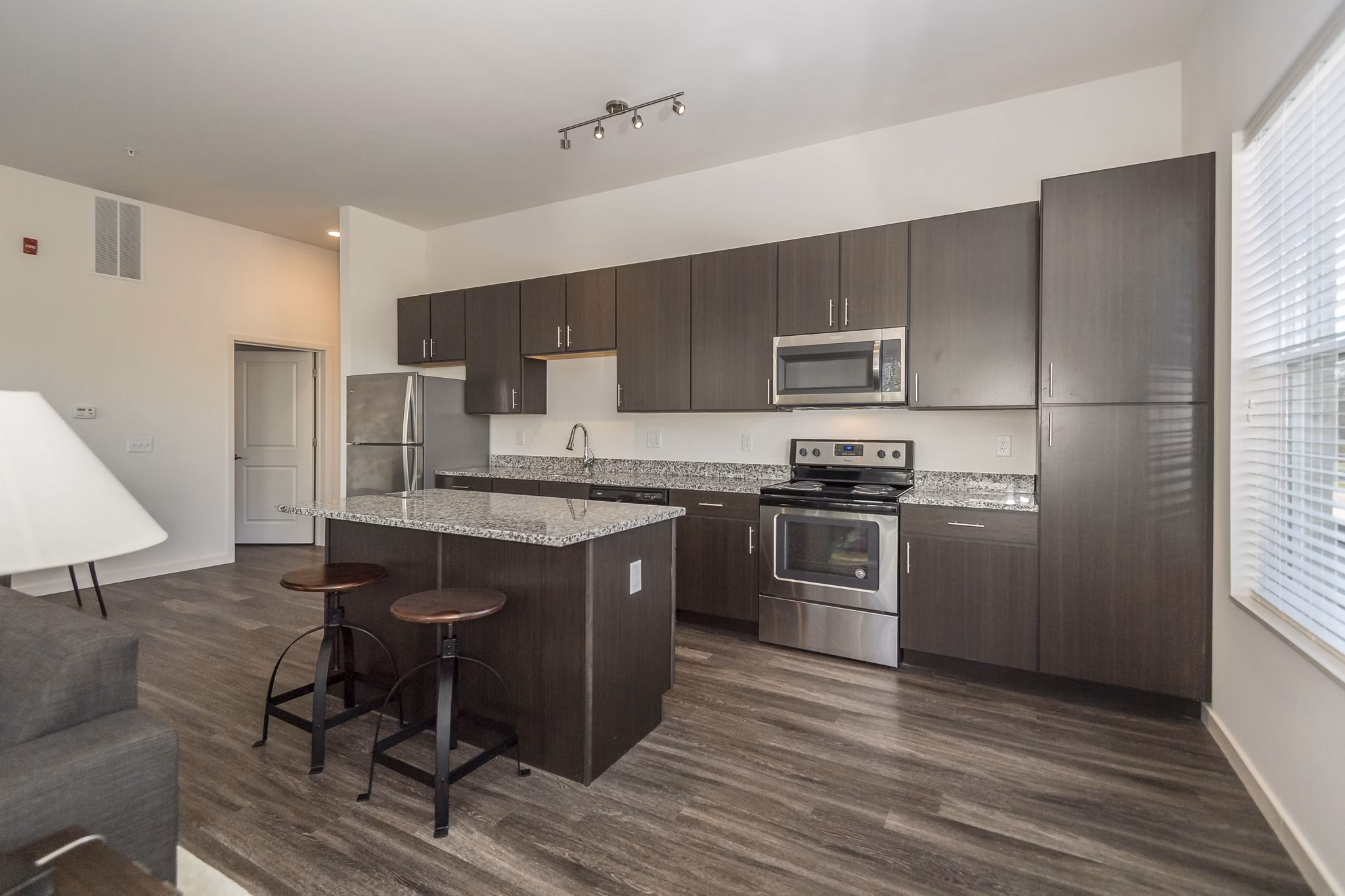 Modern kitchen with stainless steel appliances at Sunnen Station Apartments in luxury Greystar community