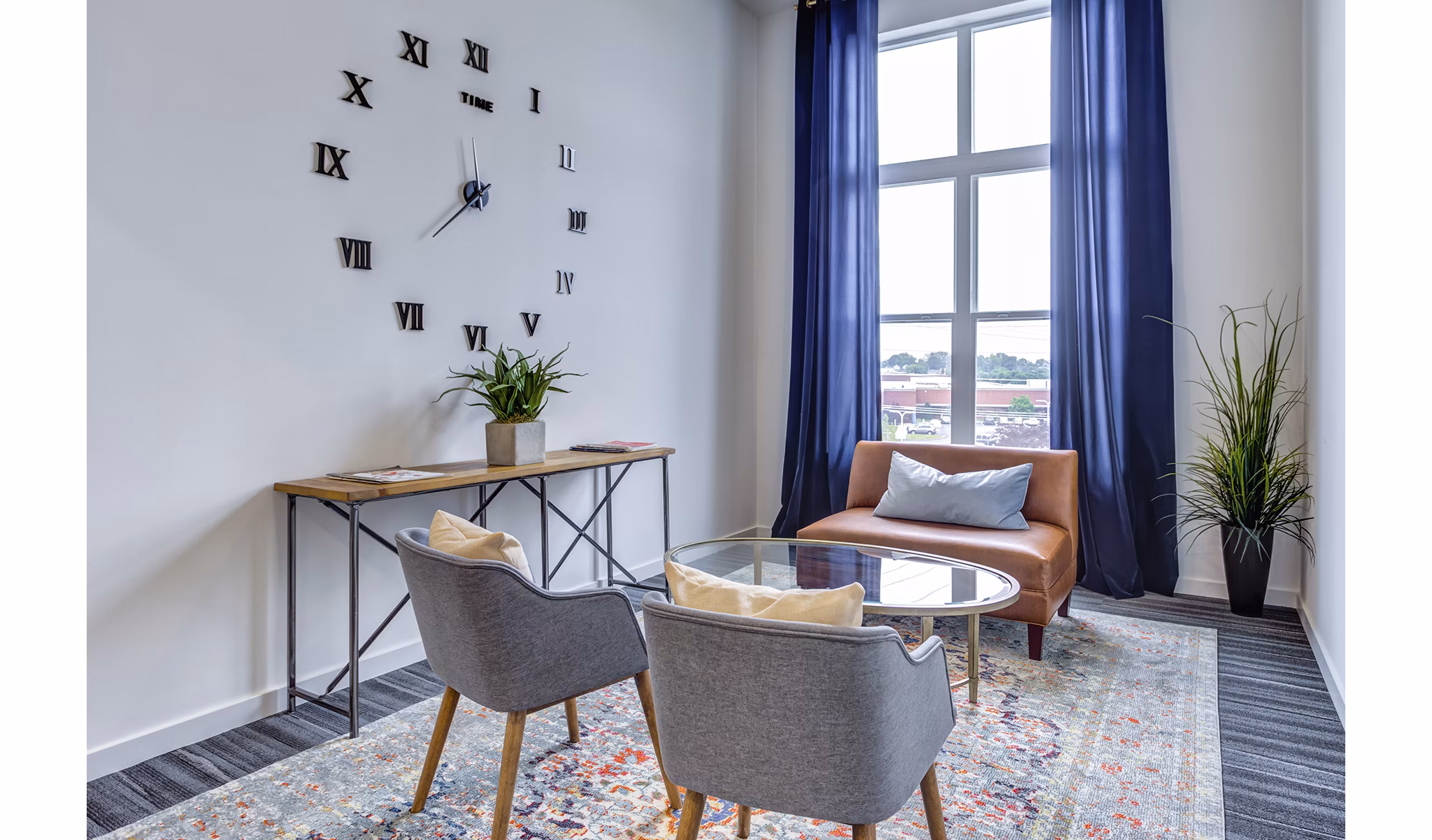 Modern living room with large windows and stylish decor at Sunnen Station Apartments, offering luxury living near public transit options