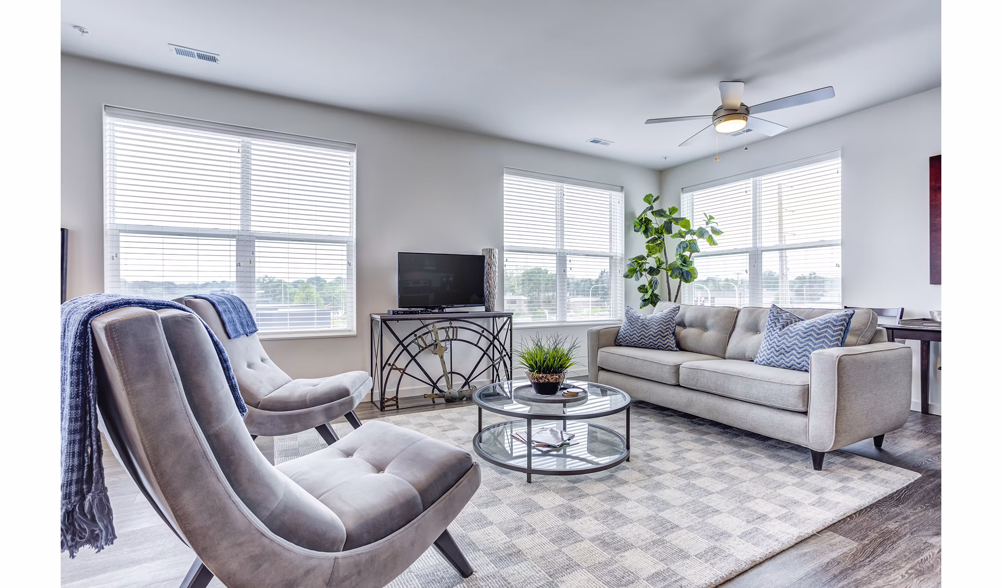 Cozy living room with modern furnishings at Sunnen Station Apartments, perfect for comfort and style in a premium residential setting
