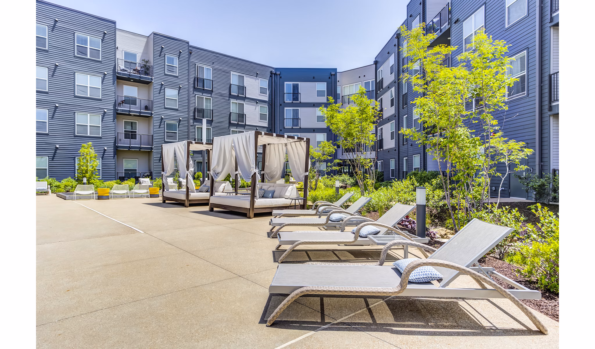 Serene outdoor pool with palm trees at The Arnold Apartments, a luxury property offering relaxing amenities in a resort-style setting