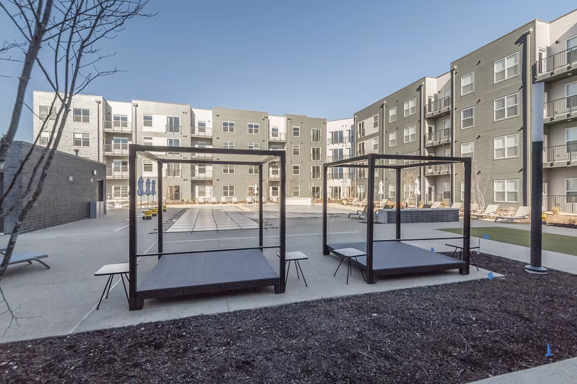 Courtyard featuring lush landscaping and seating at Sunnen Station Apartments in Maplewood