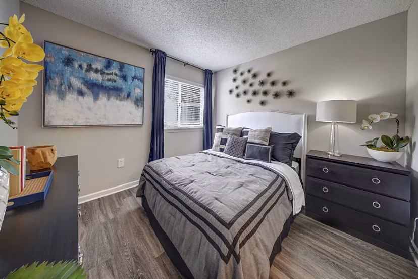 Contemporary bedroom with plush bedding at La Morada at Weston Apartments