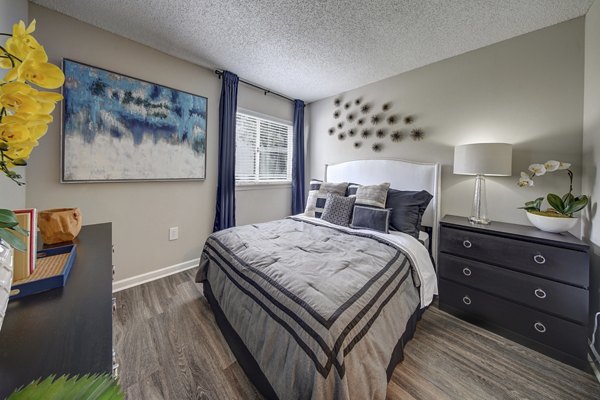 Contemporary bedroom with plush bedding at La Morada at Weston Apartments